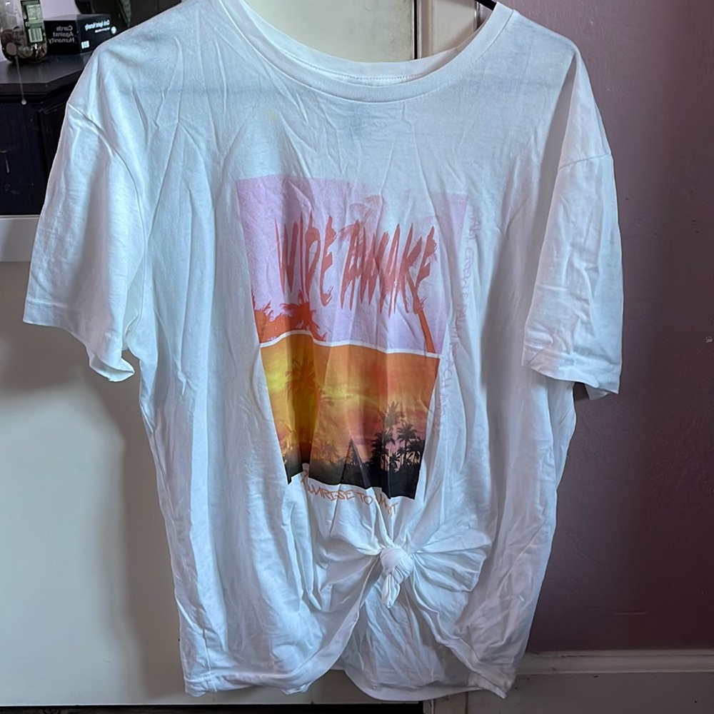 White see-through t-Shirt with a sunset and it says “wide awake”